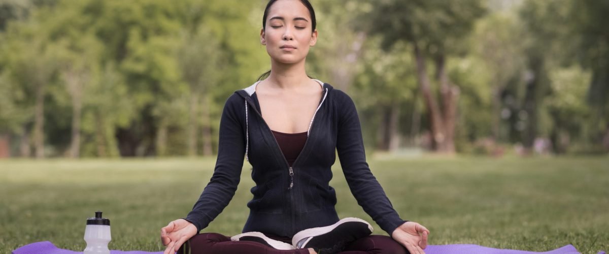 front-view-young-woman-doing-yoga-outdoors