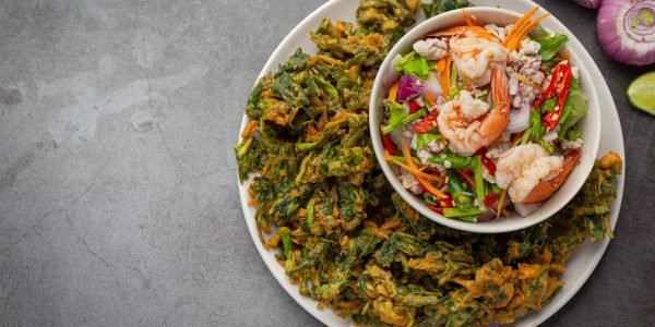 Spicy crispy morning glory salad with shrimp, spicy fresh shrimp, Thai food.