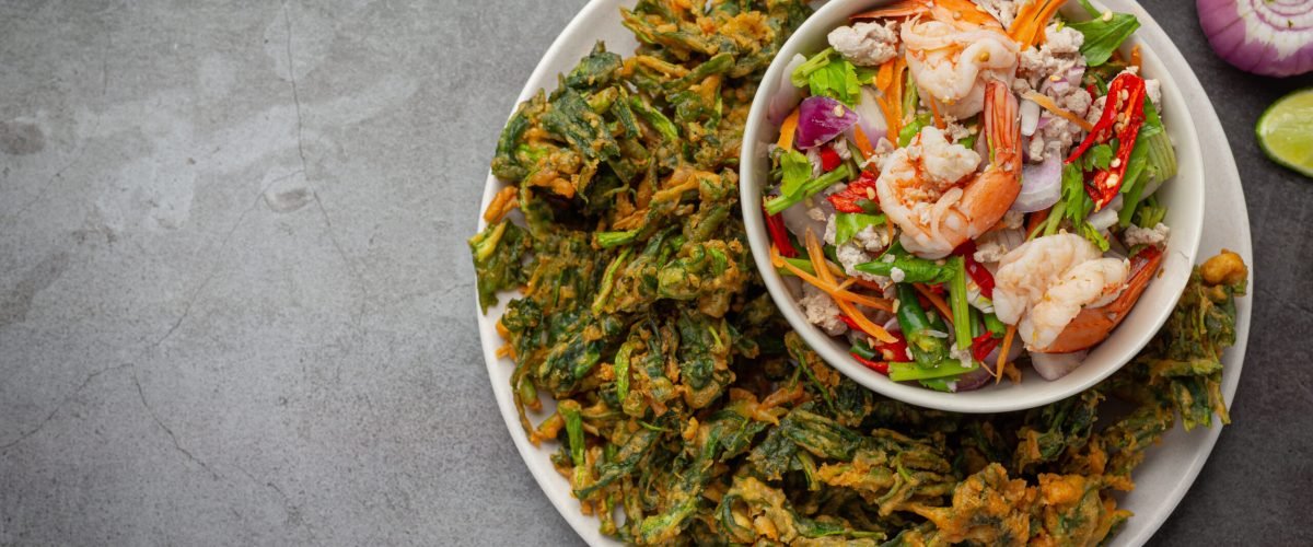 Spicy crispy morning glory salad with shrimp, spicy fresh shrimp, Thai food.